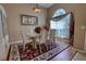 Formal dining room with seating for six, an ornate mirror, and a decorative chandelier that enhances the space's elegance at 304 Silver Pine Dr, Lake Mary, FL 32746