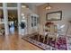 Open dining room with a table set for six, cabinet, and an open layout that flows into the living area at 304 Silver Pine Dr, Lake Mary, FL 32746