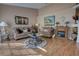 Cozy living room with wood flooring, comfortable seating, a fireplace, and stylish decor, creating an inviting space at 304 Silver Pine Dr, Lake Mary, FL 32746