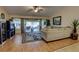 Inviting living room with vaulted ceiling, fan, and sliding glass doors that bring in abundant natural light at 304 Silver Pine Dr, Lake Mary, FL 32746