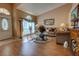 Bright living room featuring wood floors, natural lighting, and comfortable seating, ideal for relaxation and entertaining guests at 304 Silver Pine Dr, Lake Mary, FL 32746