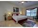 Comfortable main bedroom with a king bed, elegant decor, a ceiling fan and bright window at 304 Silver Pine Dr, Lake Mary, FL 32746