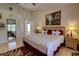 Comfortable main bedroom with a king bed, elegant decor, a ceiling fan and bright window at 304 Silver Pine Dr, Lake Mary, FL 32746