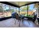 Tiled sunroom featuring a glass table, metal seating, and a view of the backyard at 304 Silver Pine Dr, Lake Mary, FL 32746