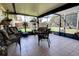 Enclosed sunroom featuring wicker seating and a fan, perfect for enjoying the outdoors year-round at 304 Silver Pine Dr, Lake Mary, FL 32746