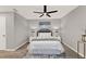 Bedroom with modern decor and white bedding, featuring plank flooring and neutral wall color at 3206 Sabal Palms Ct # A, Kissimmee, FL 34747