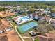 Bird's-eye view of the community's pool and tennis court nestled within the neighborhood at 3206 Sabal Palms Ct # A, Kissimmee, FL 34747