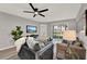 Living room with modern gray furniture, plank flooring, and sliding glass door to the backyard at 3206 Sabal Palms Ct # A, Kissimmee, FL 34747