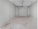 Empty garage with gray walls and cement flooring with a garage door in the back at 3208 Sabal Palms Ct # A, Kissimmee, FL 34747