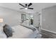 Sunlit main bedroom featuring a ceiling fan, wood floors, and sliding door access to the outdoors at 3208 Sabal Palms Ct # A, Kissimmee, FL 34747