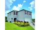 Charming two-story home featuring red shutters, a two-car garage, and a beautifully landscaped front yard at 333 Jovana Rd, Davenport, FL 33837