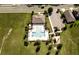 Aerial view of a community pool, playground, parking, and lush green space at 3332 Logan Berry Dr, Mount Dora, FL 32757