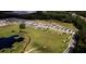 Aerial view of a community with ponds and solar panels at 3332 Logan Berry Dr, Mount Dora, FL 32757