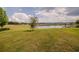 Expansive backyard featuring a large grassy field and a peaceful lake view, ideal for outdoor enjoyment at 3332 Logan Berry Dr, Mount Dora, FL 32757