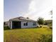 Home exterior featuring solar panels, with a screened-in porch, and green grass, enhancing energy efficiency at 3332 Logan Berry Dr, Mount Dora, FL 32757
