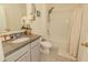 Bright bathroom showcasing a granite countertop vanity, shower-tub combo, and neutral decor for a clean look at 3332 Logan Berry Dr, Mount Dora, FL 32757
