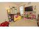 Charming Bedroom with a crib, decorative vines, and a plush display shelf, creating a cozy and whimsical space at 3332 Logan Berry Dr, Mount Dora, FL 32757