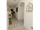 Inviting hallway featuring tile floors, arched doorways, and decorative accents, creating a warm atmosphere at 3332 Logan Berry Dr, Mount Dora, FL 32757