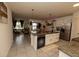 Modern kitchen featuring an island with a sink, stainless steel appliances, and open views to the living area at 3332 Logan Berry Dr, Mount Dora, FL 32757