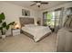 Serene main bedroom featuring a plush bed, soft lighting, and a ceiling fan for ultimate comfort and relaxation at 3332 Logan Berry Dr, Mount Dora, FL 32757