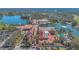 Aerial view of town square buildings with red-tile roofs, palm trees, and waterfront at 340 Grand Canal Dr, Poinciana, FL 34759