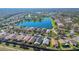 Aerial view of a lakefront community highlighting homes and the scenic lake at 340 Grand Canal Dr, Poinciana, FL 34759