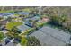 Aerial view of multiple tennis and shuffleboard courts, set amongst ponds, trees, and green spaces at 340 Grand Canal Dr, Poinciana, FL 34759