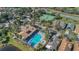 An aerial view showcasing the community pool, tennis court, and surrounding landscaping at 340 Grand Canal Dr, Poinciana, FL 34759