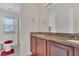 Bathroom with tile floor, granite countertop, with a view of the shower and toilet at 340 Grand Canal Dr, Poinciana, FL 34759