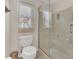 Bathroom with glass enclosed shower and white toilet, bright and airy with natural light at 340 Grand Canal Dr, Poinciana, FL 34759