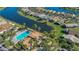 Aerial view of a community pool with a jacuzzi, lounge chairs, and landscaping at 340 Grand Canal Dr, Poinciana, FL 34759