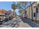 Quaint community street lined with palm trees, golf carts, and charming residential buildings at 340 Grand Canal Dr, Poinciana, FL 34759