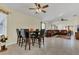 Open-concept dining area featuring tile floors, a modern table set, and a ceiling fan at 340 Grand Canal Dr, Poinciana, FL 34759