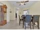 Cozy dining area featuring tile flooring, a ceiling fan, and a modern table set at 340 Grand Canal Dr, Poinciana, FL 34759