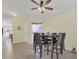 Bright dining area featuring tile floors, a ceiling fan, and a modern table with chairs at 340 Grand Canal Dr, Poinciana, FL 34759