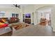 Spacious living room featuring tile flooring, a ceiling fan, and a comfortable leather sectional at 340 Grand Canal Dr, Poinciana, FL 34759