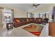 Bright living room featuring tile floors, a leather sectional, and natural light at 340 Grand Canal Dr, Poinciana, FL 34759