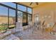 Cozy sunroom with tile floor, ceiling fan, and large windows with a view of the landscaped backyard at 340 Grand Canal Dr, Poinciana, FL 34759