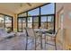 Relaxing sunroom with tile floors, ceiling fan, and large windows, perfect for enjoying the outdoors at 340 Grand Canal Dr, Poinciana, FL 34759