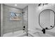 Beautiful bathroom with a tiled shower and tub, as well as a bright window for natural light and a modern sink at 3627 Arch St, Orlando, FL 32808