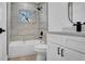 Beautiful bathroom with a tiled shower and tub, as well as a bright window for natural light and a modern sink at 3627 Arch St, Orlando, FL 32808