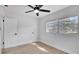 Bedroom with light wood floors, ceiling fan and two windows bringing in natural light at 3627 Arch St, Orlando, FL 32808