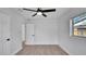 Bedroom featuring light floors, a ceiling fan, and a window with natural light at 3627 Arch St, Orlando, FL 32808