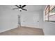 Bedroom featuring neutral paint, fan and window with natural light, as well as access to the bathroom at 3627 Arch St, Orlando, FL 32808