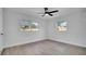 Bedroom with neutral walls, ceiling fan, and two windows bringing in natural light at 3627 Arch St, Orlando, FL 32808