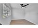 Bedroom featuring light floors, a ceiling fan, and a window with natural light at 3627 Arch St, Orlando, FL 32808