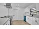 Contemporary kitchen featuring stone countertops, and white cabinetry, and stainless steel appliances at 3627 Arch St, Orlando, FL 32808