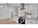 Bright kitchen with stainless steel range hood, modern cabinets, quartz countertops, and lots of natural light at 3627 Arch St, Orlando, FL 32808