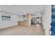 Bright open-concept living space with wood-look floors connecting to a modern kitchen at 3627 Arch St, Orlando, FL 32808