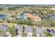 Aerial view of property and the community clubhouse, pool, and landscaping at 3640 Solana Cir # A, Clermont, FL 34711